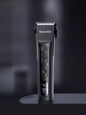 Black rechargeable hair clipper from Trendsi with adjustable blades and ergonomic design for easy grooming.