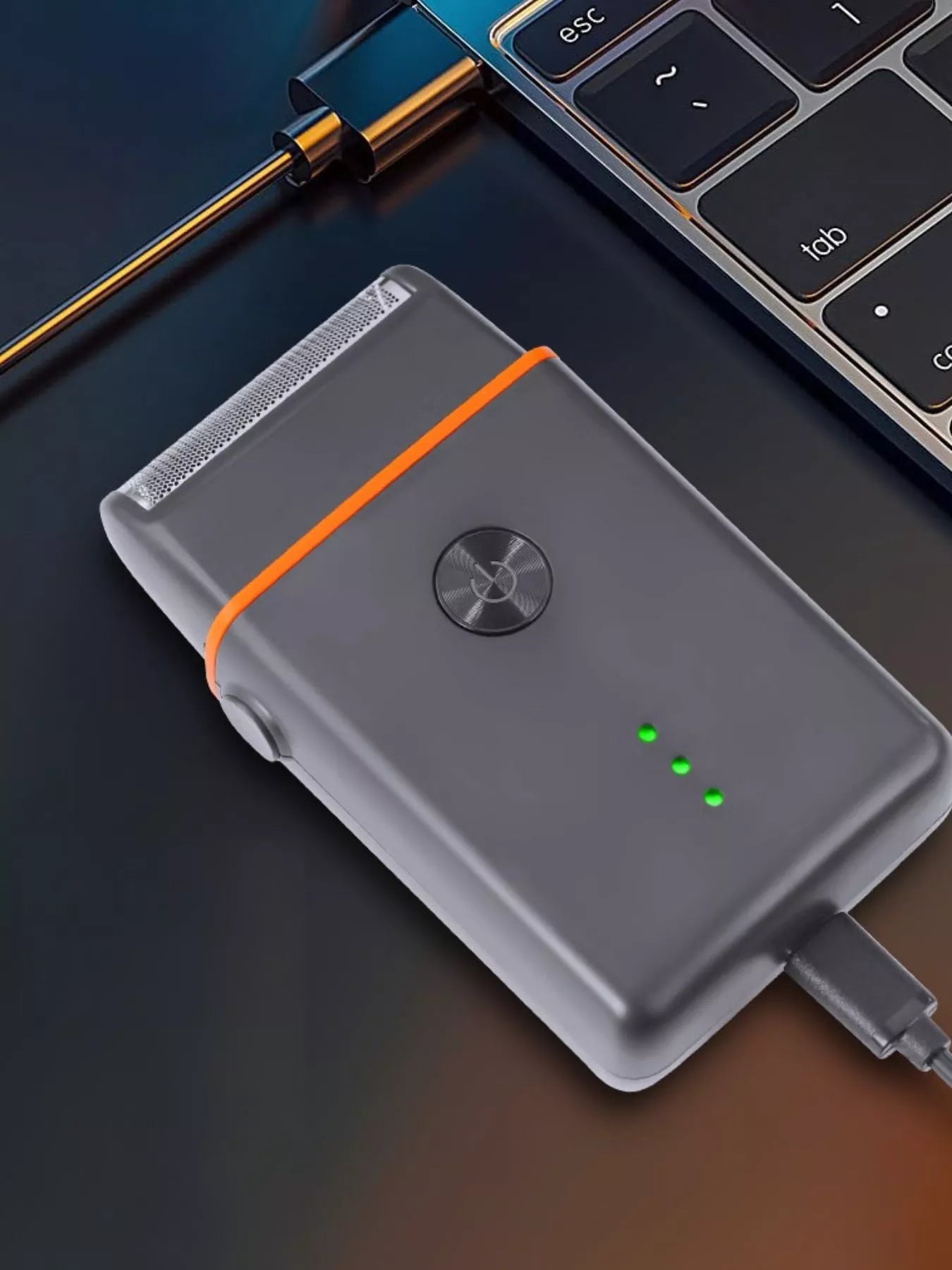 Black and orange portable mini shaver by Trendsi, compact and lightweight for easy grooming on the go.