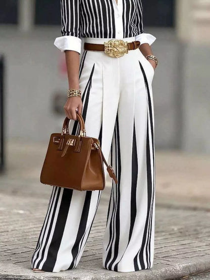 Black high-waisted wide-leg striped pants by Trendsi, featuring a stylish silhouette and bold vertical stripe pattern.