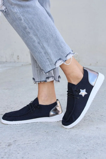 Black pewter Forever Link Star lace-up flat sneakers by Trendsi, featuring stylish design and comfortable flat sole.
