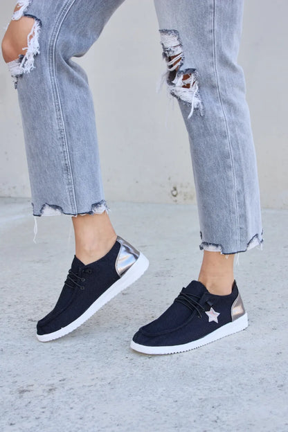 Black Forever Link Star lace-up flat sneakers by Trendsi with star details and comfortable flat sole.