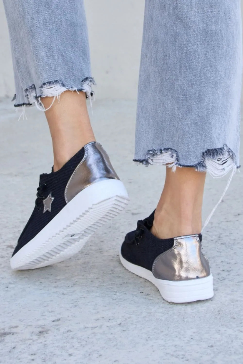 Black Pewter Forever Link Star Lace-Up Flat Sneakers by Trendsi, showing the stylish sneakers with lace-up design and star accents.