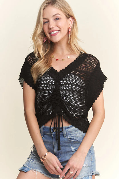 Black ADORA crochet top by Trendsi with drawstring details, featuring a stylish, lightweight crochet design and relaxed fit.