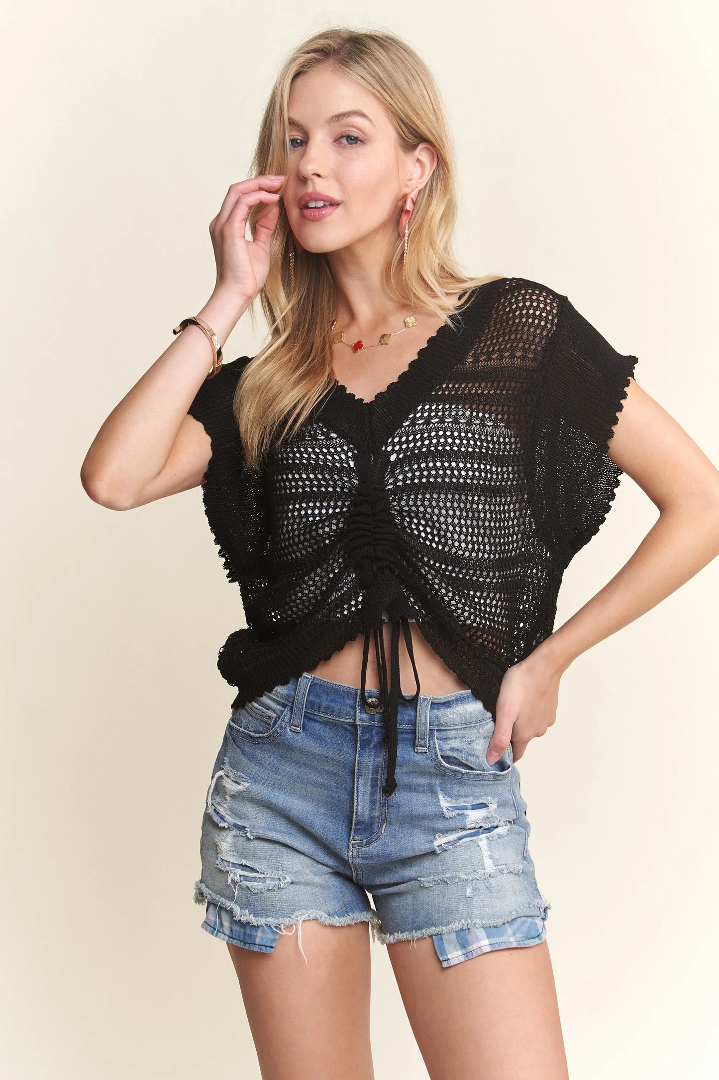 Black ADORA crochet top with drawstring details, featuring a stylish and breathable design by Trendsi.
