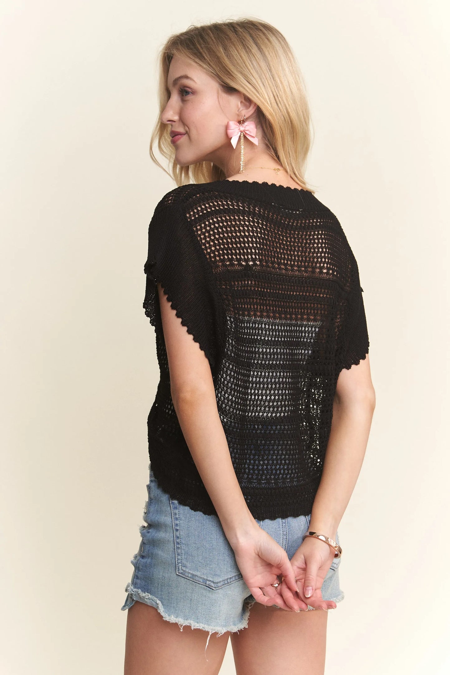 Black ADORA crochet top by Trendsi with drawstring detail, featuring a fitted design and intricate crochet pattern.