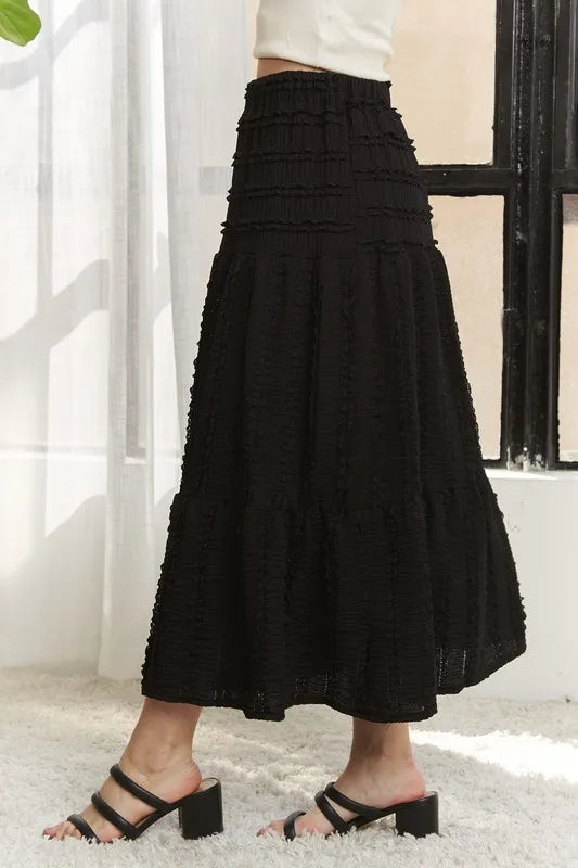 Black ADORA elastic waistband tiered midi skirt by Trendsi, featuring a flowy, layered design perfect for casual or dressy outfits.