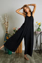 Black plus size ADORA elastic ruffle shoulder jumpsuit by Trendsi, featuring a full-length design and stylish shoulder ruffles.
