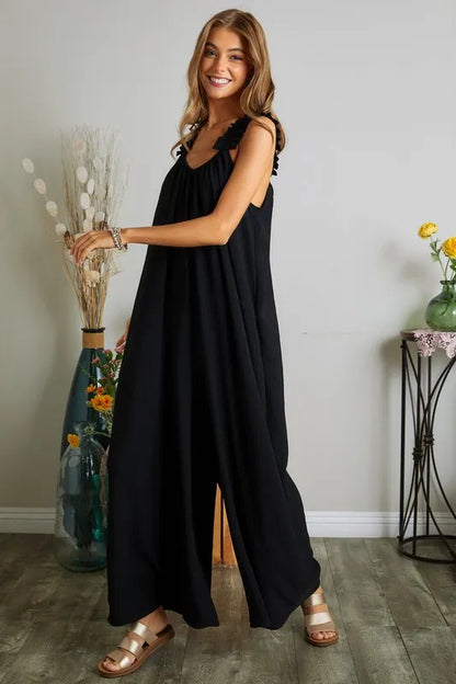 Black plus size ADORA jumpsuit by Trendsi featuring elastic ruffle shoulder details and a full-length fit.