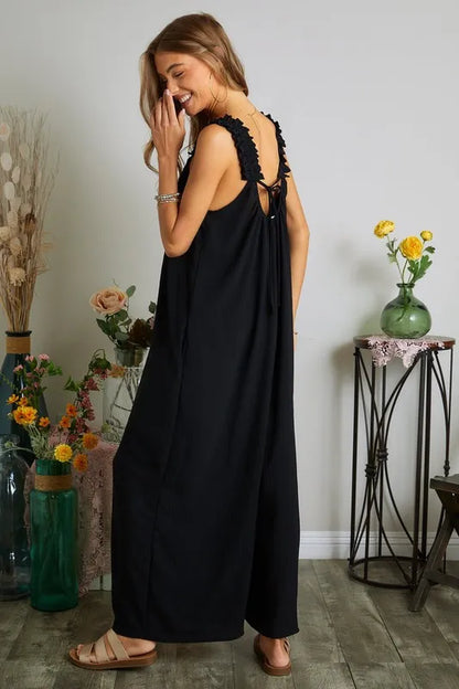 Black plus size ADORA elastic ruffle shoulder jumpsuit by Trendsi featuring a full-length design and stylish ruffle details.