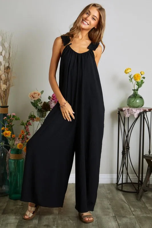 Black plus size ADORA elastic ruffle shoulder jumpsuit by Trendsi, featuring a full-length fit and stylish ruffle details.