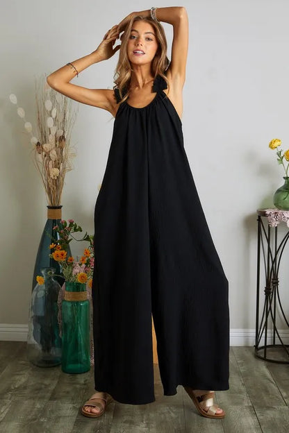 Black plus size ADORA elastic ruffle shoulder jumpsuit by Trendsi, featuring a full-length design and stylish ruffle details.