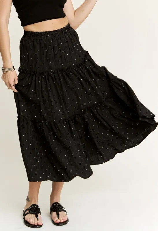 Black ADORA Rhinestone Accent Tiered Skirt by Trendsi featuring sparkling rhinestone details and layered fabric design.