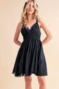Black Aemi+Co lace detail mini cami dress by Trendsi, featuring delicate lace accents and a fitted sleeveless design.