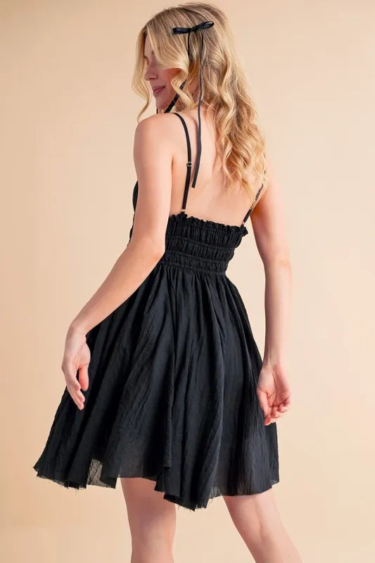 Black Aemi+Co lace detail mini cami dress from Trendsi, featuring delicate lace accents and a stylish mini length.