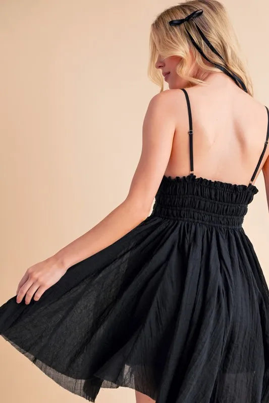 Black Aemi+Co lace detail mini cami dress from Trendsi, featuring delicate lace accents and a chic, fitted silhouette.
