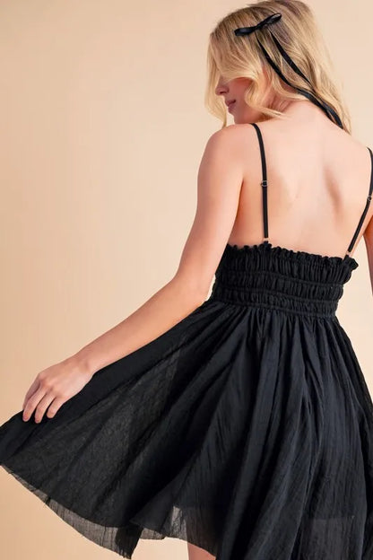Black Aemi+Co lace detail mini cami dress from Trendsi, featuring delicate lace accents and a chic, fitted silhouette.