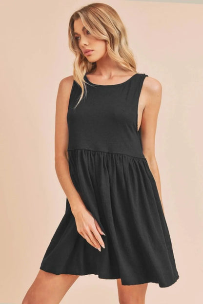 Black Aemi + Co round neck mini tank dress by Trendsi, featuring a fitted sleeveless design for casual or stylish wear.