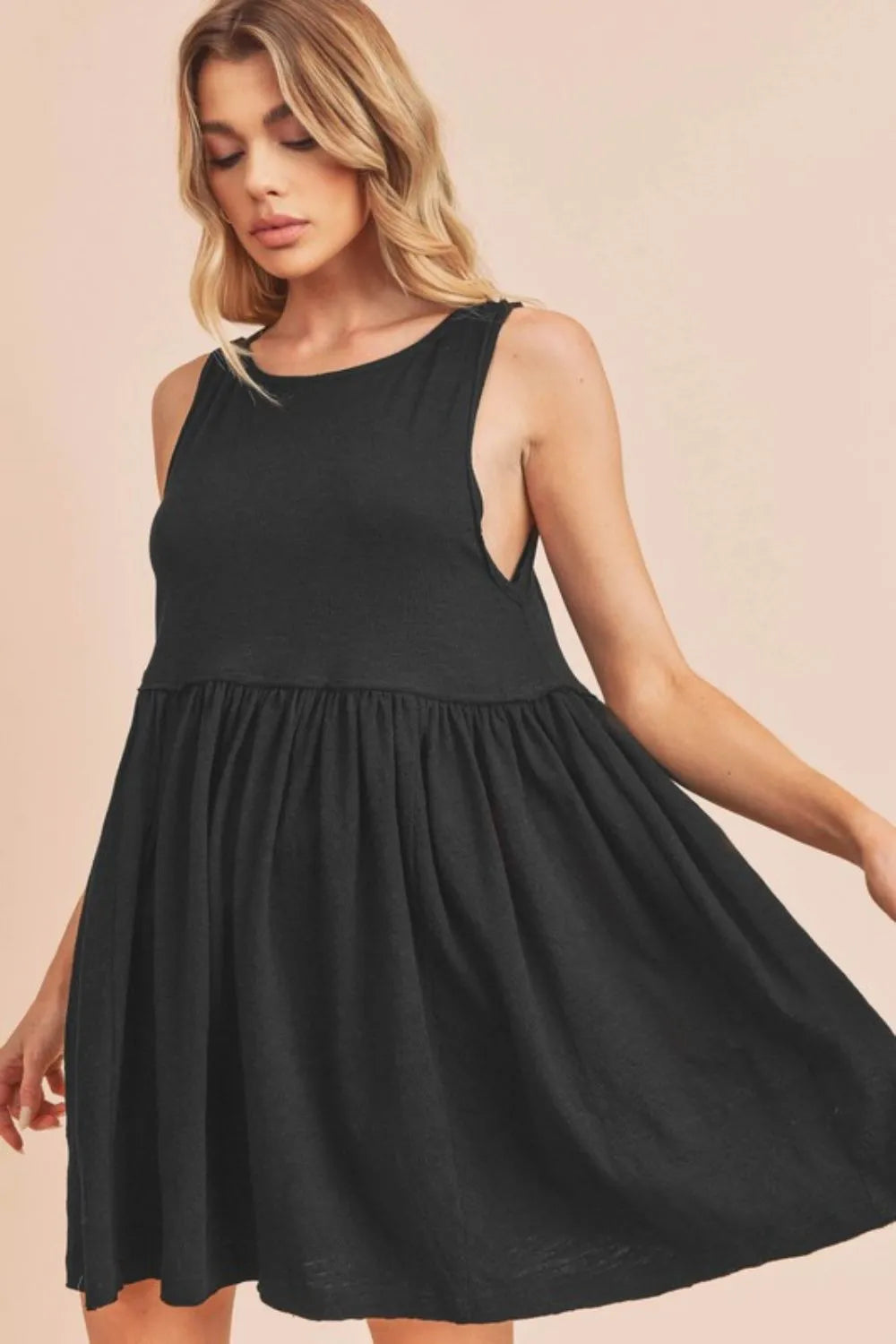 Black Aemi + Co round neck mini tank dress by Trendsi, sleeveless design, fitted silhouette, and versatile for casual or dressy looks.
