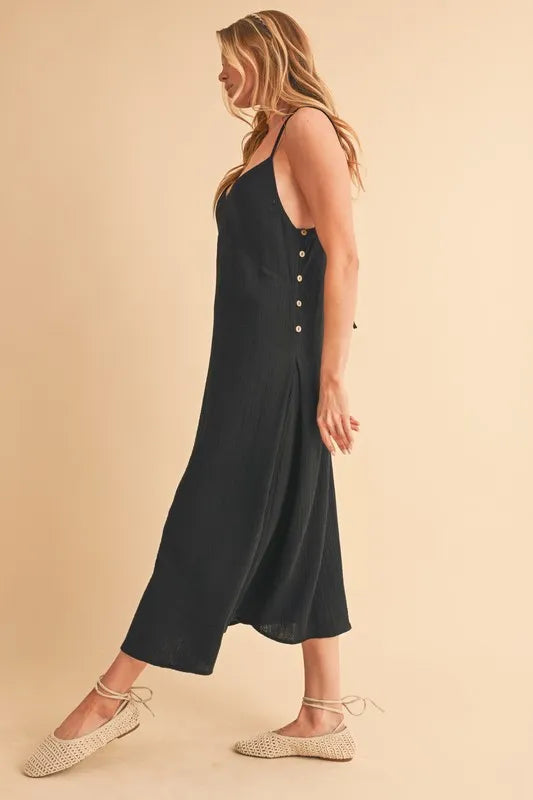 Black Aemi+Co side button midi cami dress with adjustable straps and side slit, designed by Trendsi.