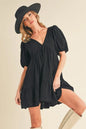 Black Aemi+Co tied-back ruffled short sleeve mini dress by Trendsi, featuring a stylish design and feminine ruffle details.