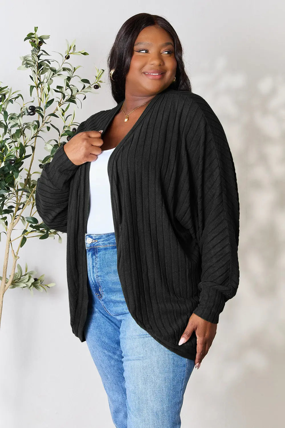 Black Trendsi Basic Bae full-size ribbed cocoon cardigan displayed on a model, showcasing its relaxed fit and textured knit fabric.