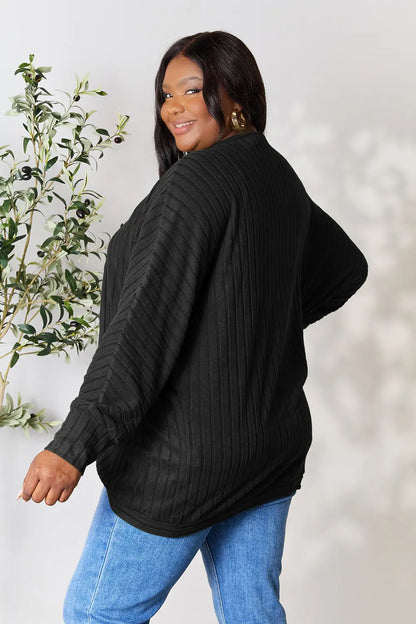 Black Basic Bae Full Size Ribbed Cocoon Cardigan by Trendsi, shown on a model, featuring a cozy, oversized fit and textured knit fabric.