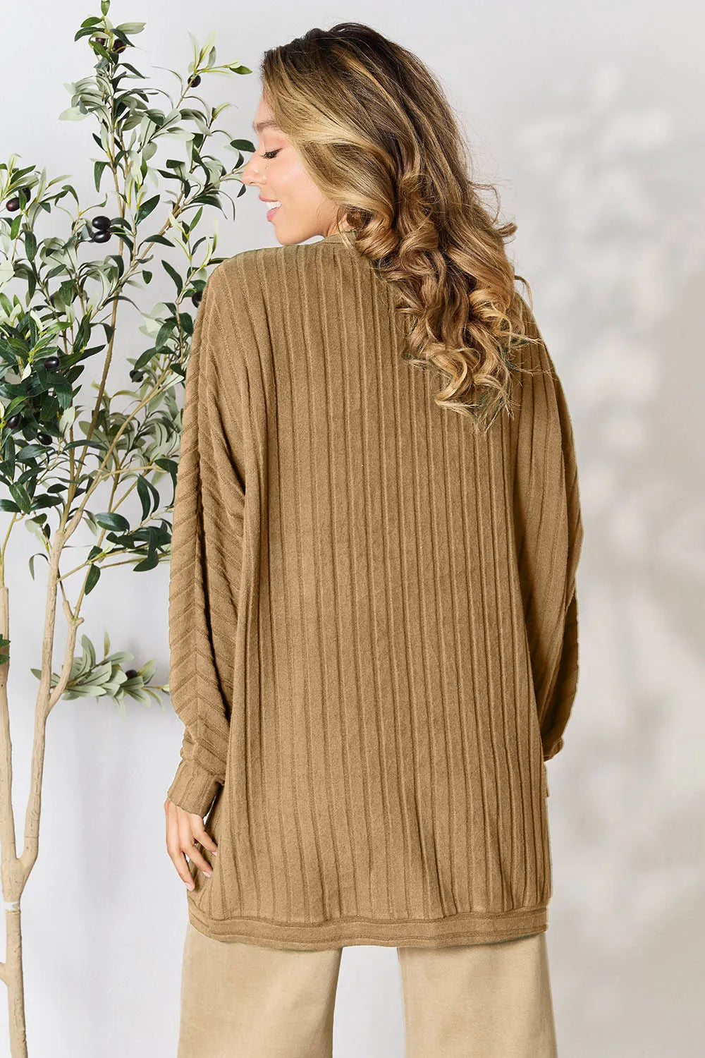 Black Basic Bae Full Size Ribbed Cocoon Cardigan by Trendsi, showing the cozy, oversized fit and ribbed knit texture.