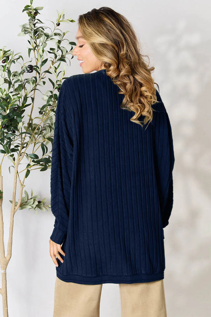 Black Basic Bae full-size ribbed cocoon cardigan by Trendsi, shown on a hanger with a relaxed fit and textured ribbed fabric.