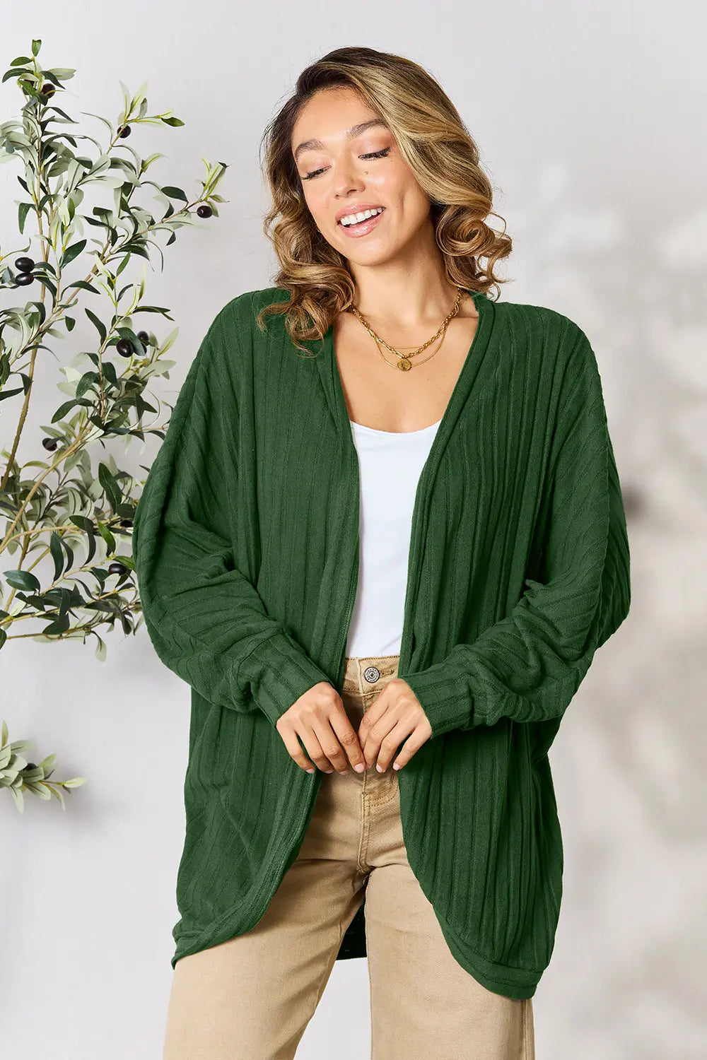 Black Basic Bae full-size ribbed cocoon cardigan from Trendsi, shown on a model, featuring a soft, cozy knit fabric and relaxed fit.