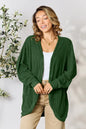 Black Basic Bae full-size ribbed cocoon cardigan from Trendsi, shown on a model, featuring a soft, cozy knit fabric and relaxed fit.