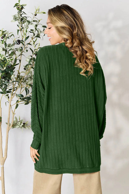Black Trendsi Basic Bae full-size ribbed cocoon cardigan displayed on a hanger, showcasing its relaxed, oversized fit and textured fabric.