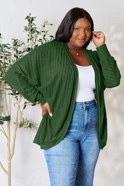 Black Trendsi Basic Bae full-size ribbed cocoon cardigan displayed on a model, showcasing its cozy, oversized fit and textured knit fabric.