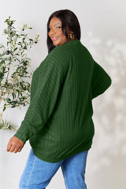 Black Trendsi Basic Bae full-size ribbed cocoon cardigan draped on a hanger, showcasing its relaxed fit and textured fabric.