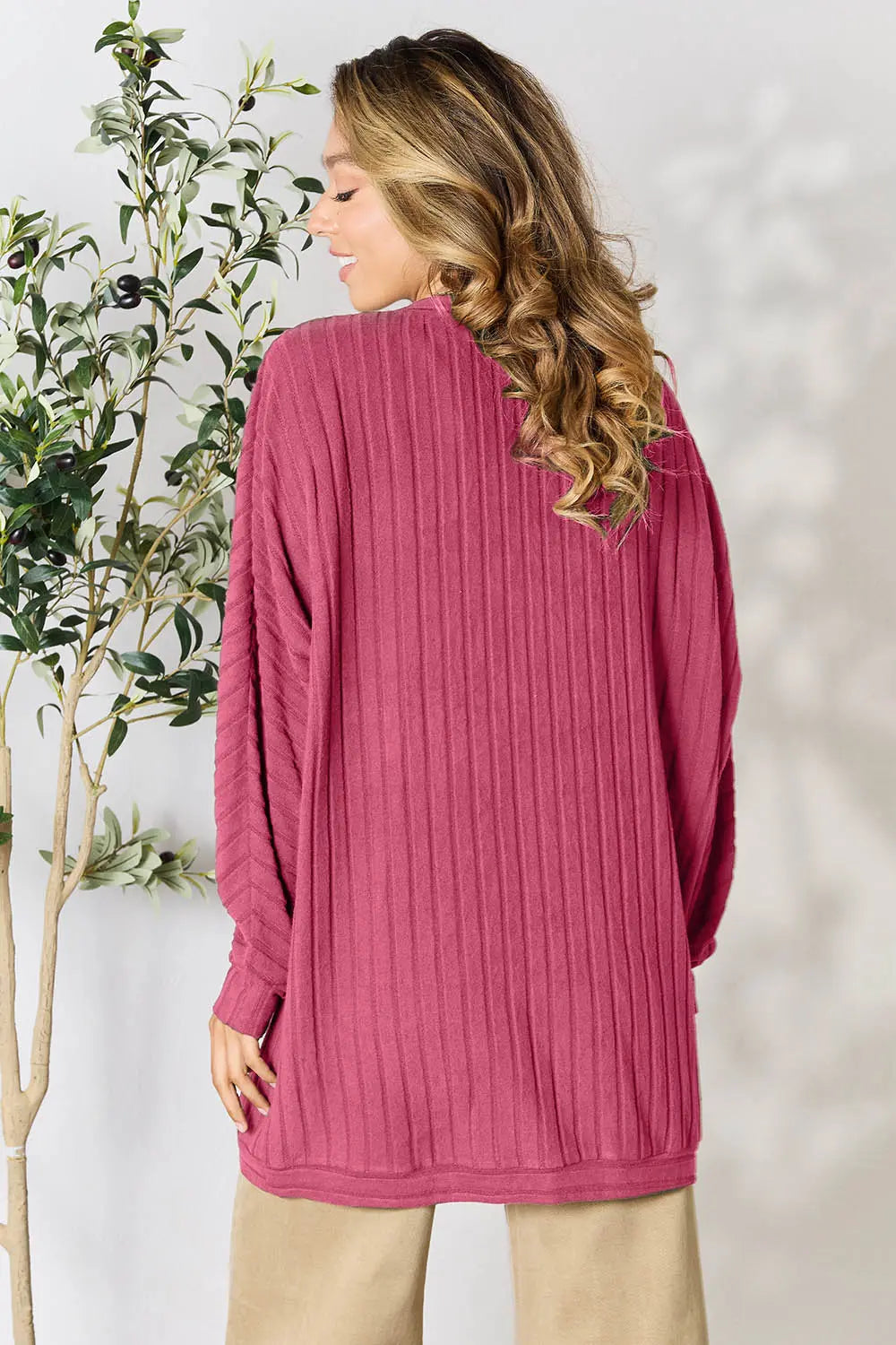 Black Trendsi Basic Bae full-size ribbed cocoon cardigan displayed on a hanger with a relaxed fit and textured ribbed knit fabric.