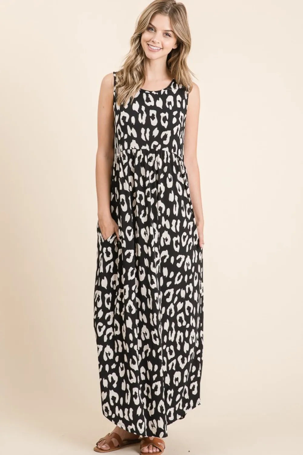 Black BOMBOM Leopard Maxi Dress with Pockets by Trendsi, featuring a flowing silhouette and stylish animal print.
