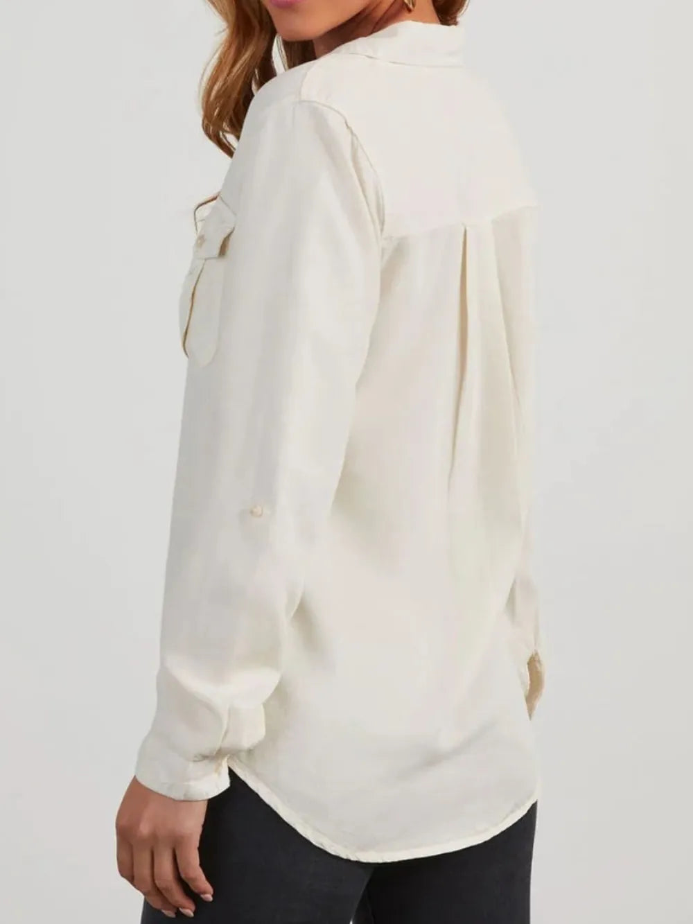 Black denim top with a collared neckline and roll-tab sleeves, featuring a stylish and casual design.