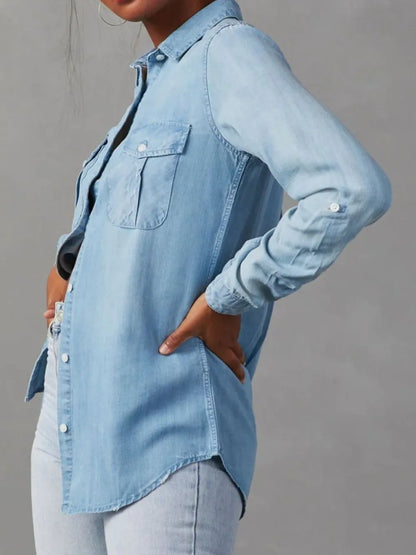 Black denim top with a collared neckline and roll-tab sleeves, featuring a stylish and casual design.