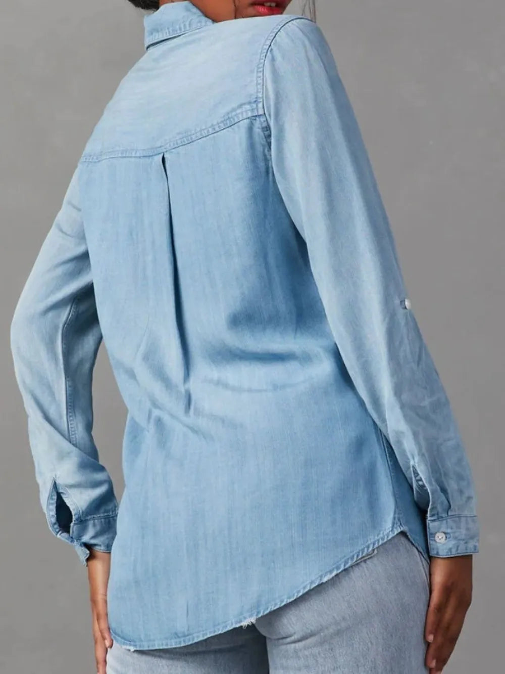 Black denim top with a collared neck and roll-tab sleeves, featuring a stylish and casual design from Trendsi.