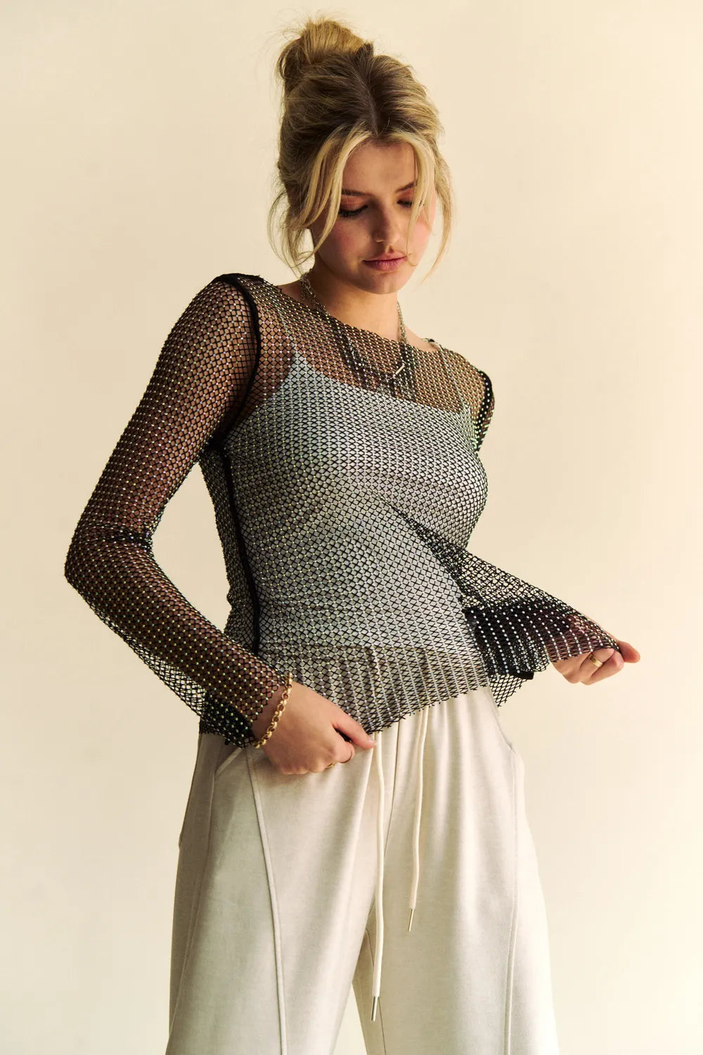 Black Davi & Dani sparkling rhinestone sheer mesh round neck top by Trendsi, featuring intricate rhinestone embellishments and sheer fabric.
