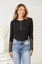 Black Trendsi Double Take crochet lace hem sleeve button top, featuring a stylish design with lace details and button accents.