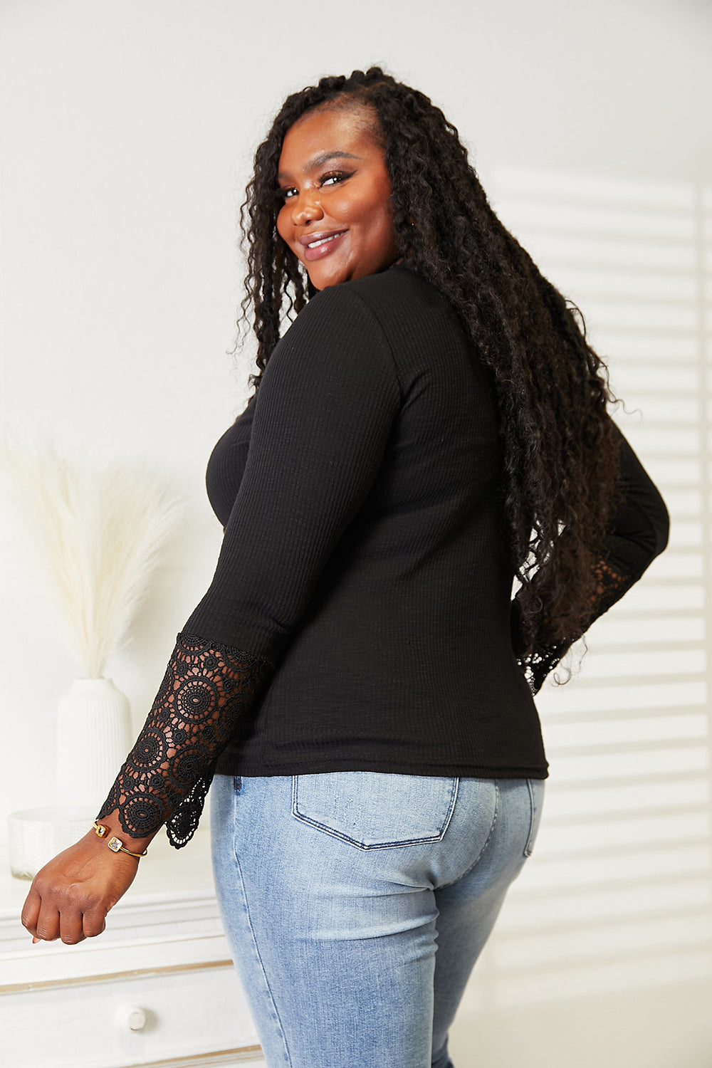 Black double take crochet lace hem sleeve button top by Trendsi featuring a relaxed fit with lace detailing and button accents.