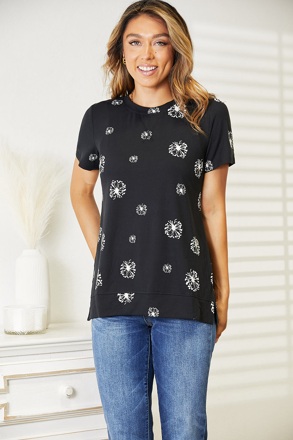 Black Trendsi Double Take Dandelion print round neck T-shirt with a bold dandelion design on the front.