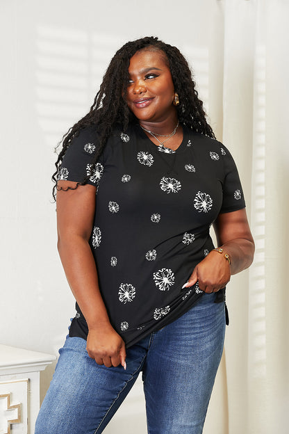 Black double take dandelion print round neck T-shirt by Trendsi, showcasing a stylish floral design on soft cotton fabric.