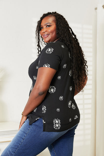 Black double take dandelion print round neck T-shirt by Trendsi, featuring a graphic dandelion design on soft fabric.