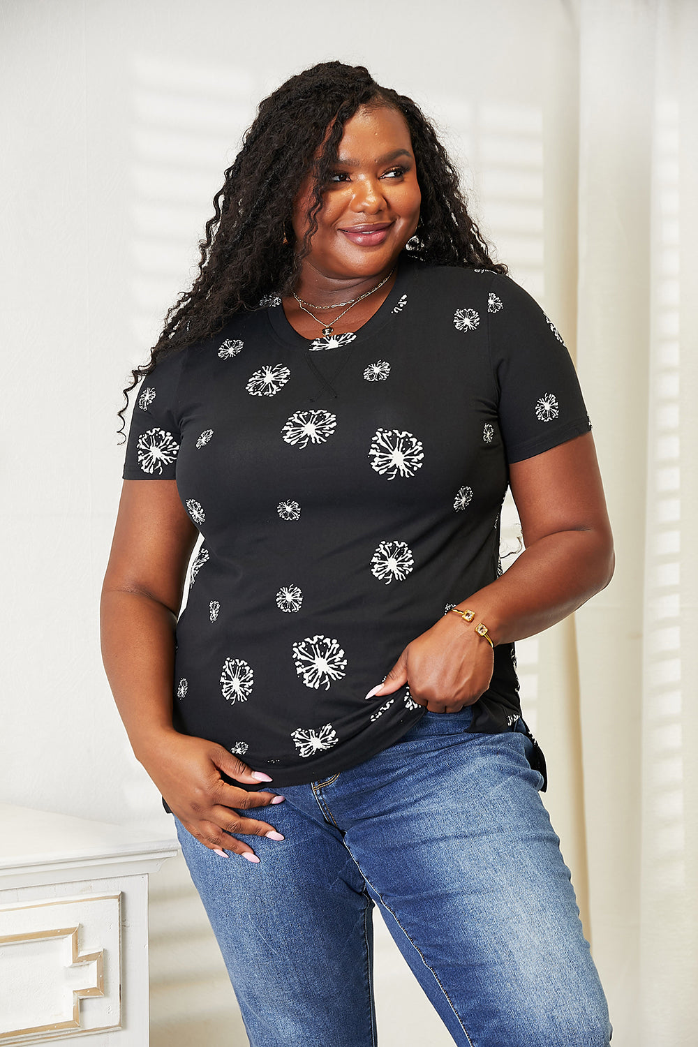 Black double take dandelion print round neck T-shirt by Trendsi, featuring a floral design and comfortable fit.