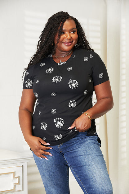 Black double take dandelion print round neck T-shirt by Trendsi, featuring a floral design and comfortable fit.