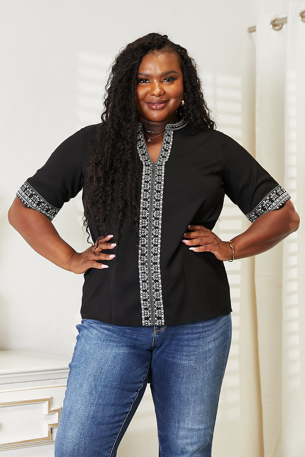 Black Trendsi Double Take embroidered notched neck top with intricate floral embroidery and a stylish notched neckline.