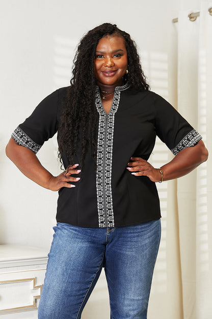 Black Trendsi Double Take embroidered notched neck top with intricate floral embroidery and a stylish notched neckline.