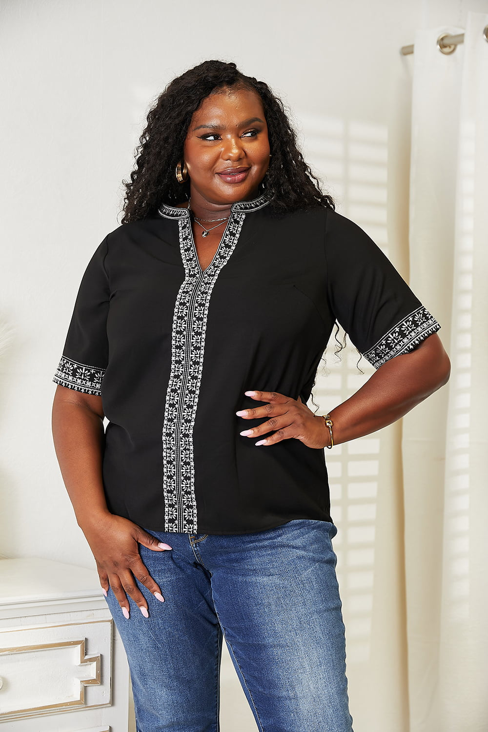 Black embroidered notched neck top by Trendsi, featuring a stylish double take design and lightweight fabric.