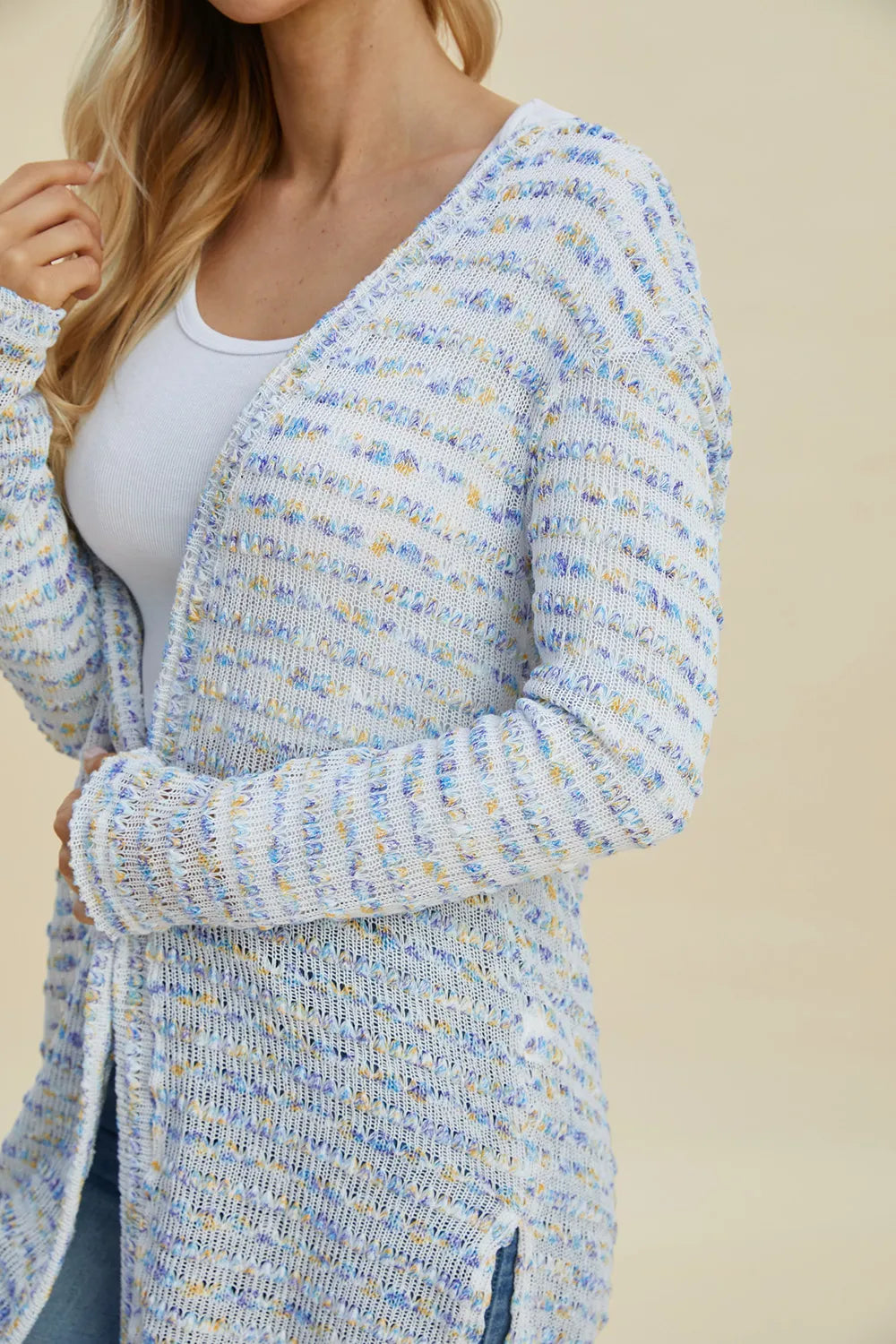 Black Trendsi Double Take full-size open front longline cardigan displayed hanging with a relaxed fit and open front design.